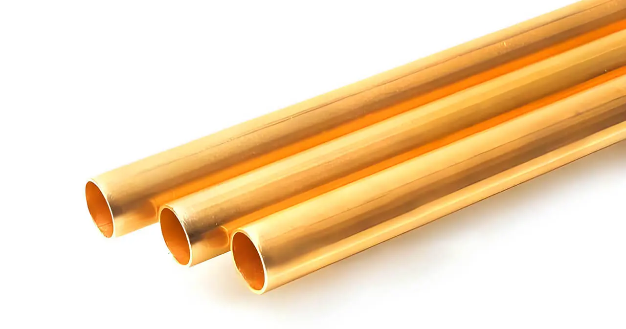 Three polished gold hollow tubes arranged diagonally on a white background, raw material for jewelry bead manufacturing