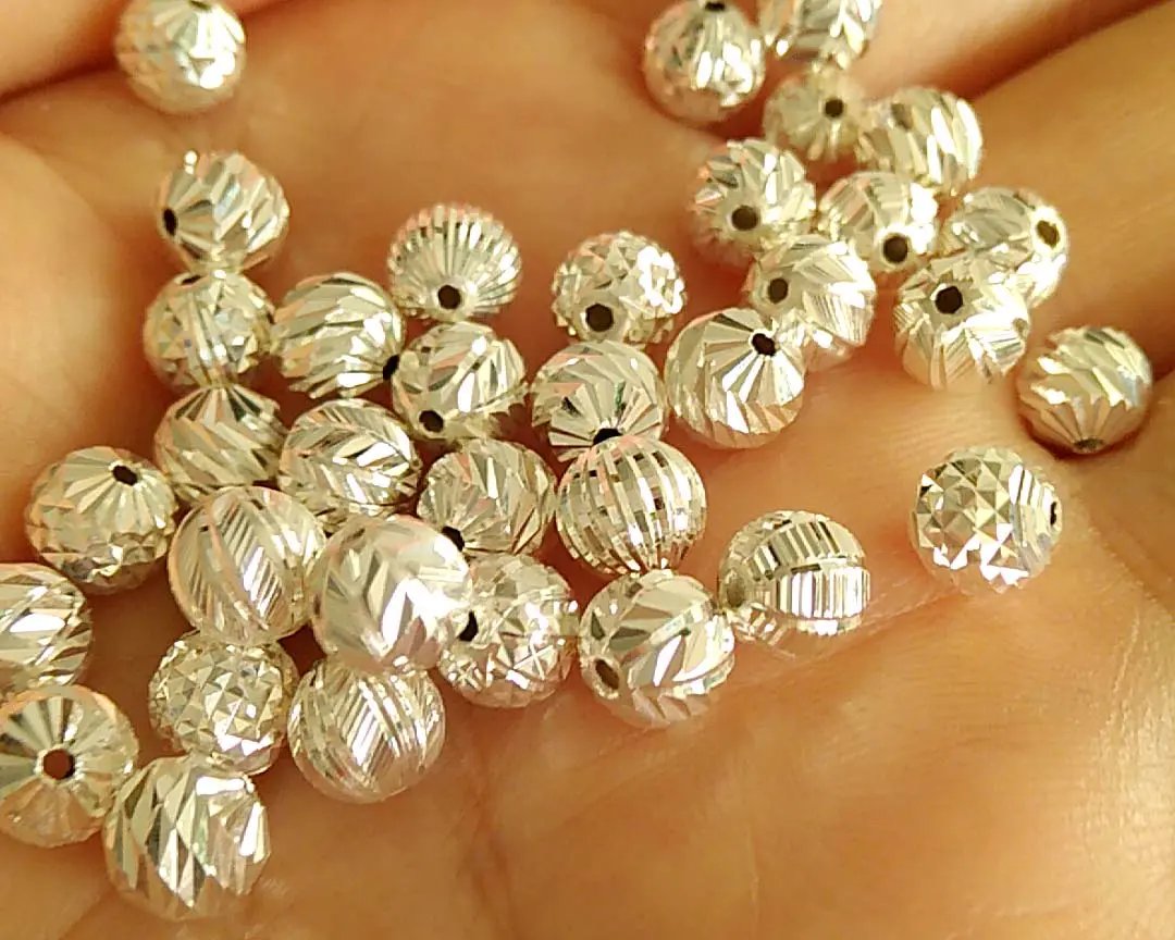 Ball Diamond Cutting Machine(1 head)(Image1) Sparkling gold hollow faceted beads with a textured surface, perfect for handmade necklaces and bracelets