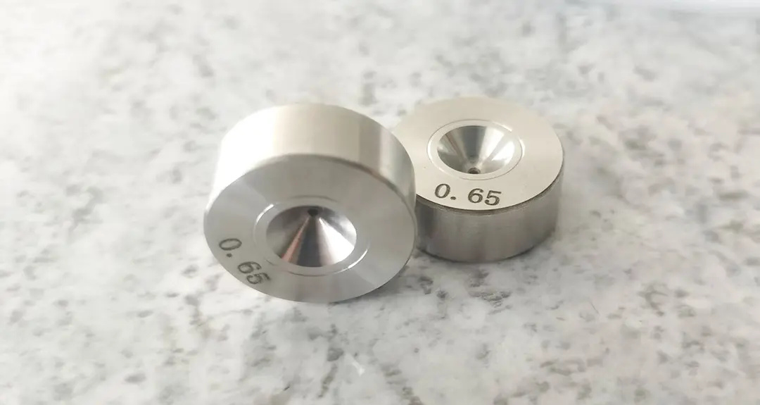 Close-up of wire drawing die hole with high-precision tolerance, showing smooth inner surface for fine wire drawing